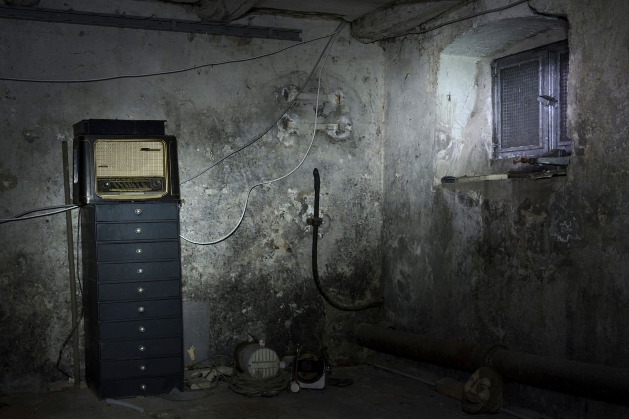 A dated basement room with a computer and a window, representing the mold removal service in Jacksonville, FL.