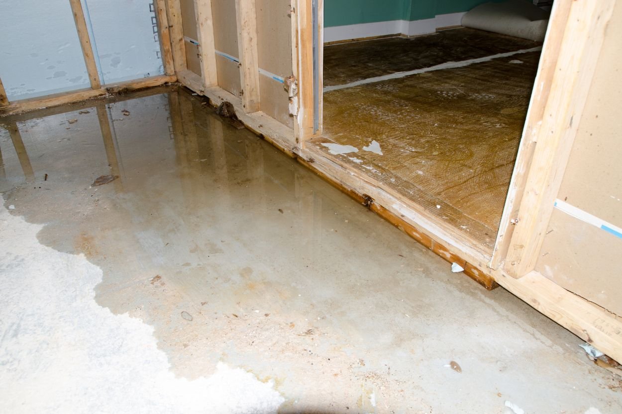 A room flooded with water, featuring a door, illustrating the impact of water damage and the need for restoration services in Jacksonville.